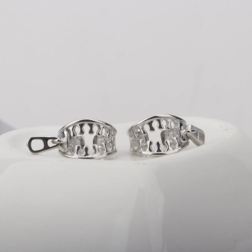 A pair of geometric copper clip-on earrings with a bone clip fastening and linear detail.