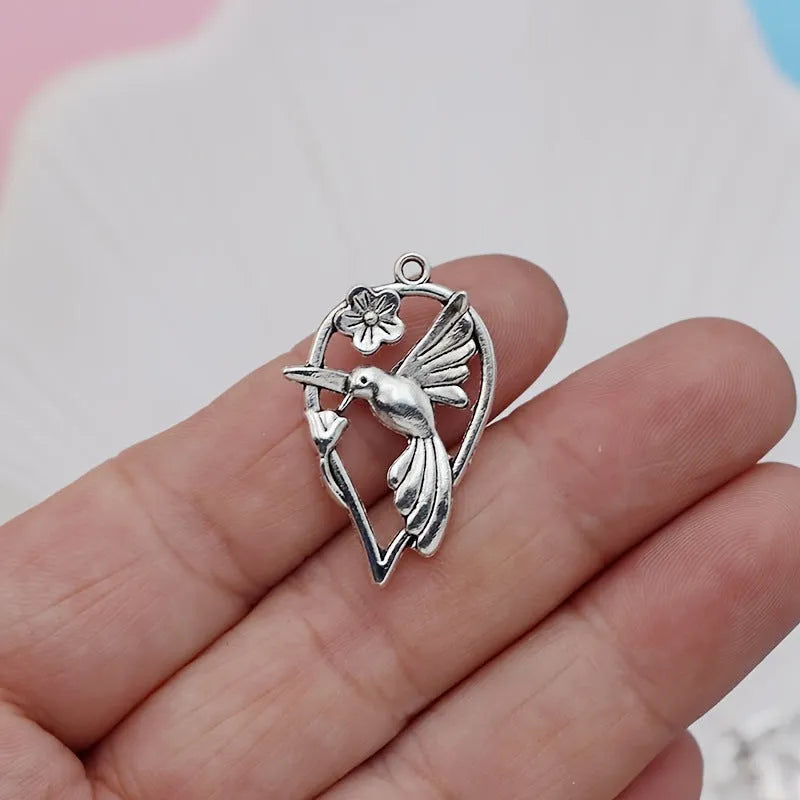Alloy magpie bird pendant charm with electroplated finish on a white background.