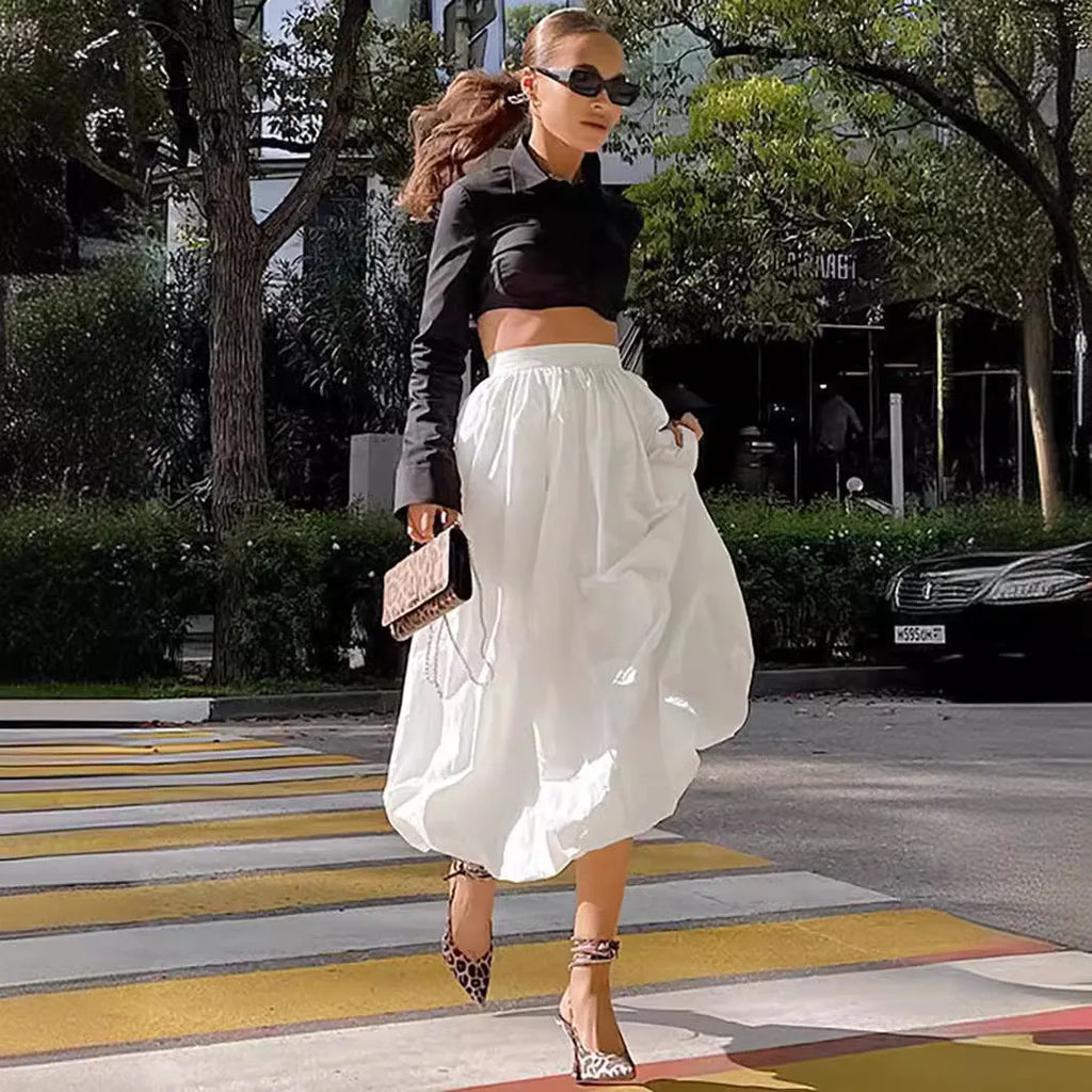 Women's solid colour cotton long skirt with elasticated waistband in black and white.