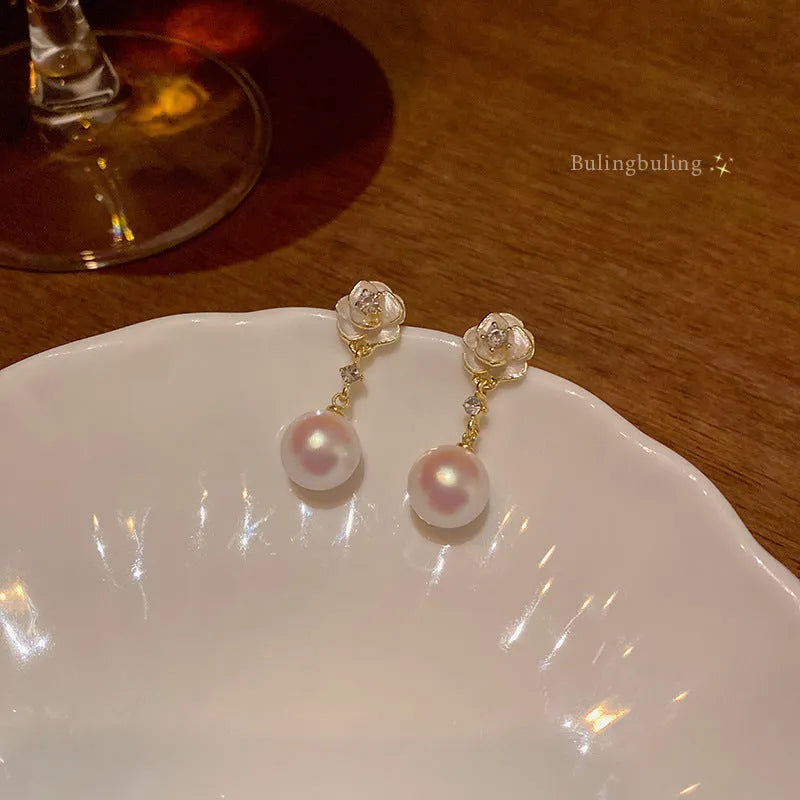 A pair of women's alloy stud earrings shaped like a detailed camellia flower in a 'Camellia' colour.