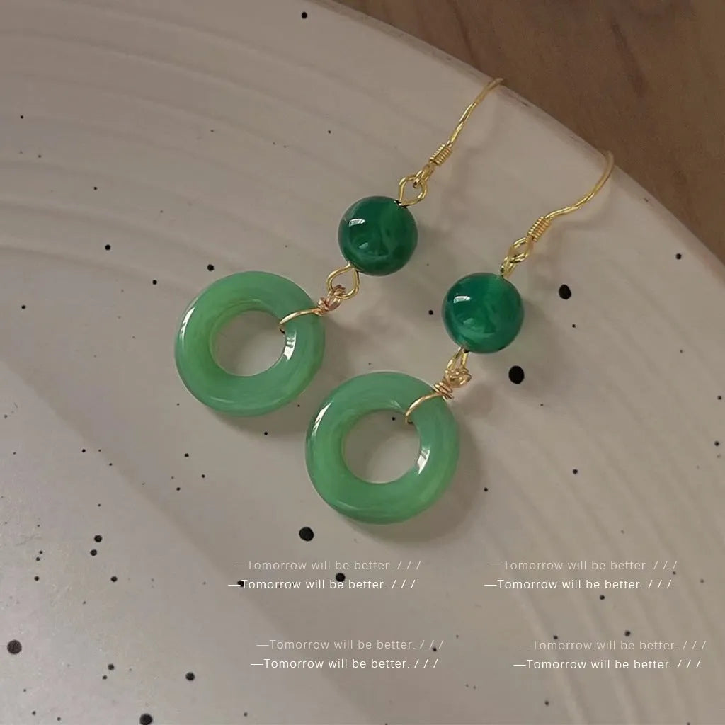 Green and gold Chinese style peace buckle shape earrings with geometric ring design.