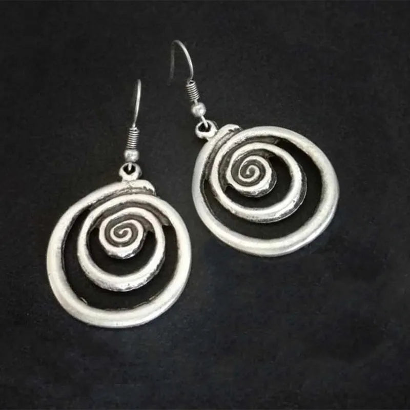 Silver alloy geometric spiral earrings with a distressed finish, measuring 2.6cm by 5cm.