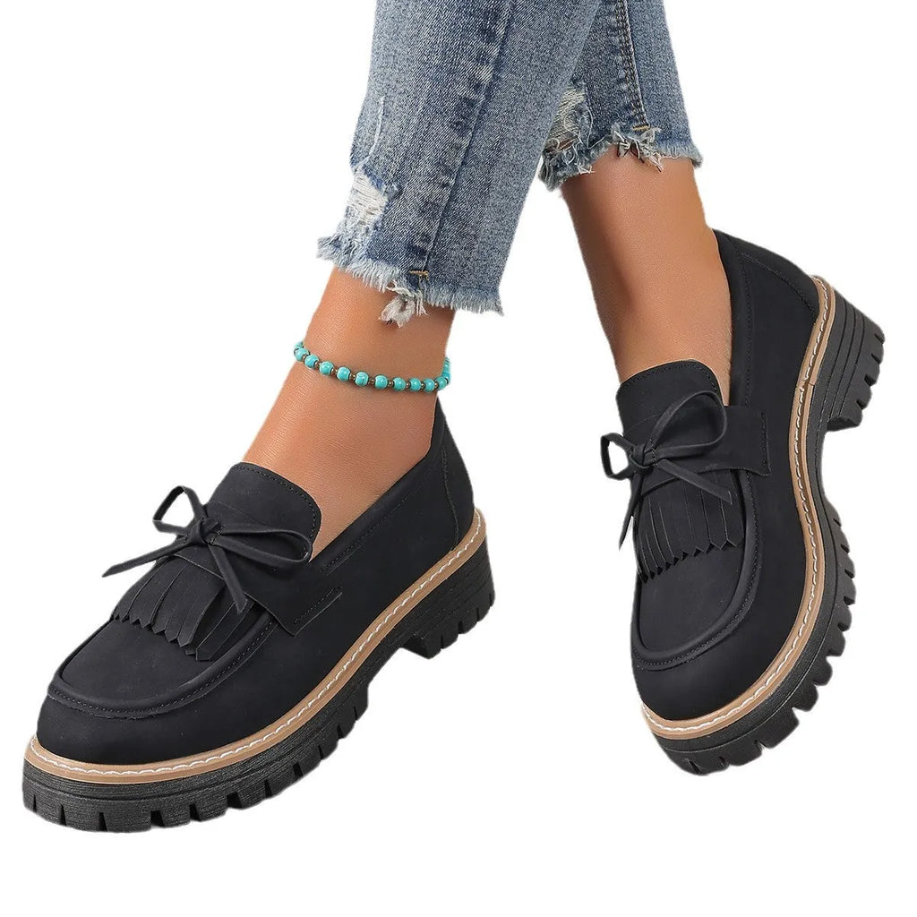 Brown plus size women's loafers with a tassel and bowknot detail on a chunky thick heel.
