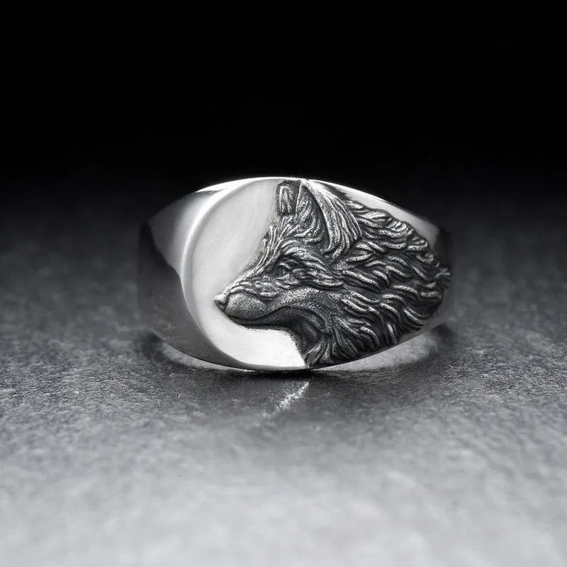 Men's silver wolf head alloy ring in geometric design on display