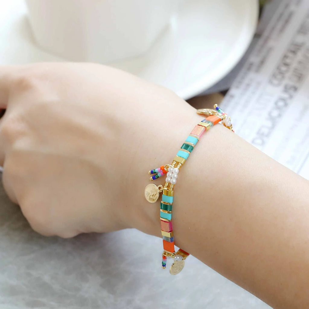 Women's imitation pearl beaded bracelet showing six pearl-lift colour variations with manual processing