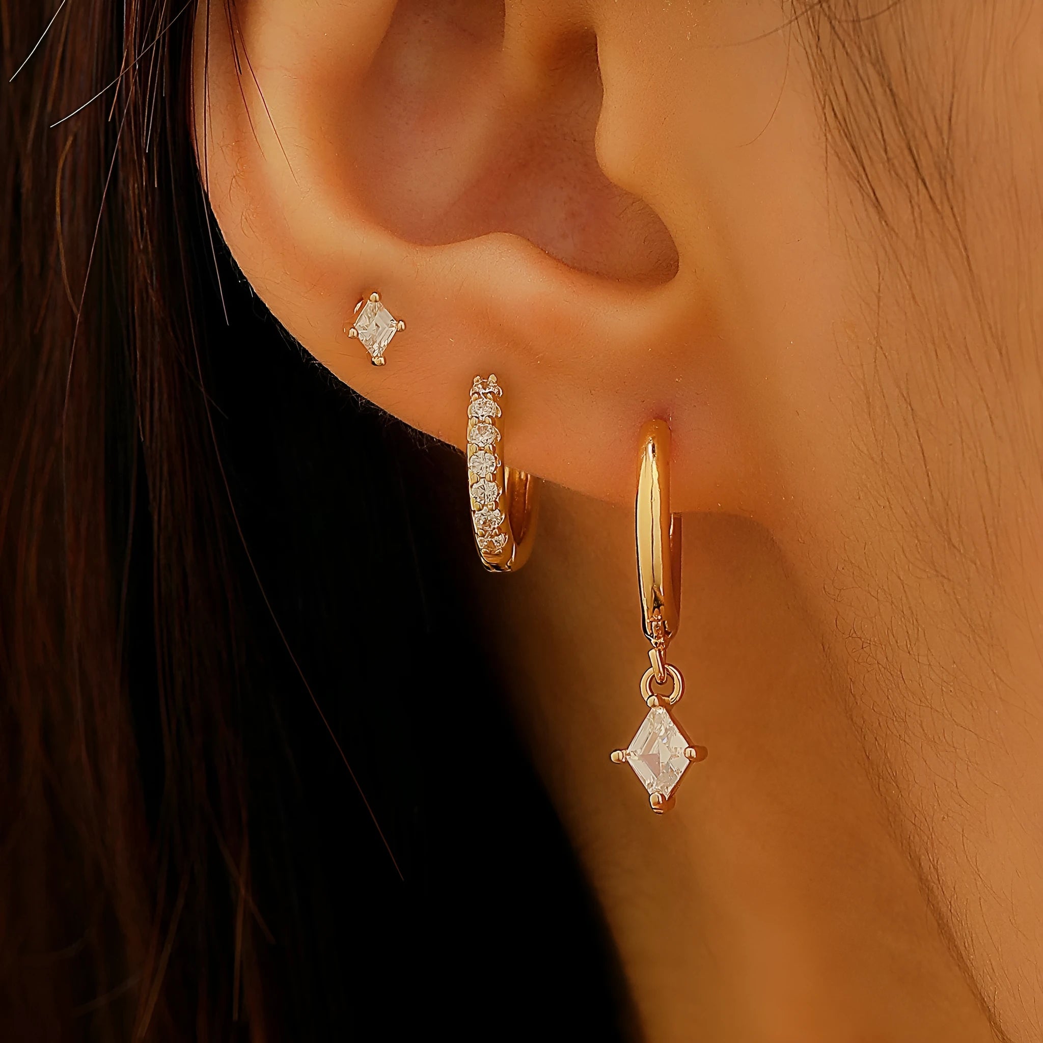 Gold and white geometric earring set with zircon stones showing three earring types: dangling, stud, and clasp.