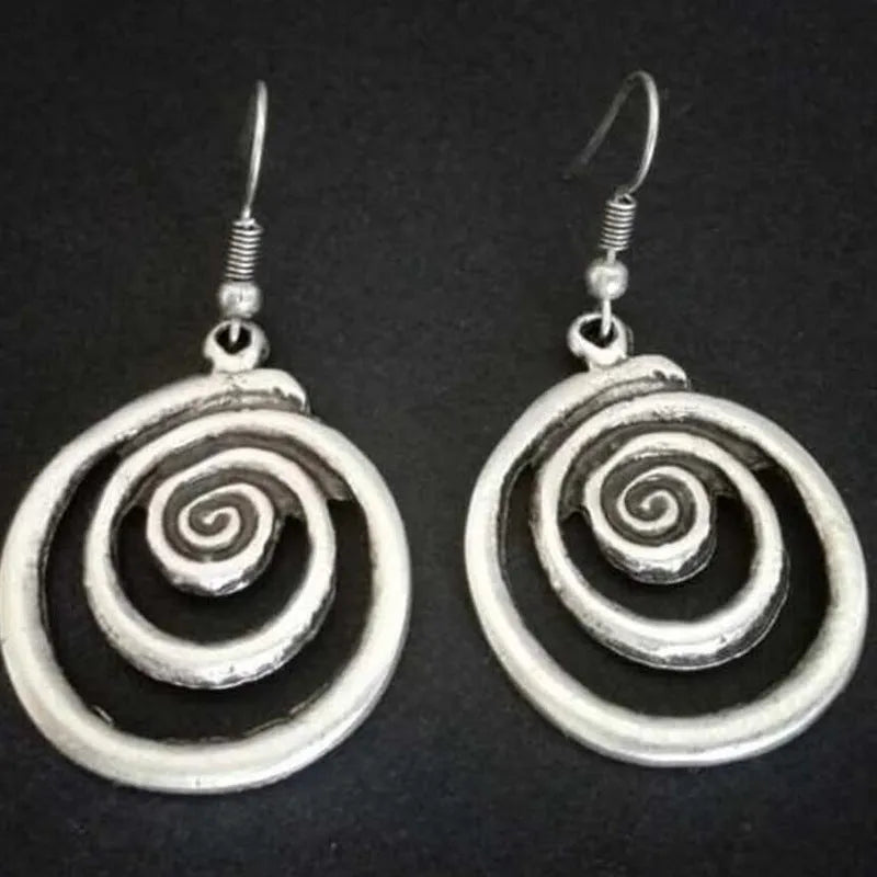 Silver alloy geometric spiral earrings with a distressed finish, measuring 2.6cm by 5cm.
