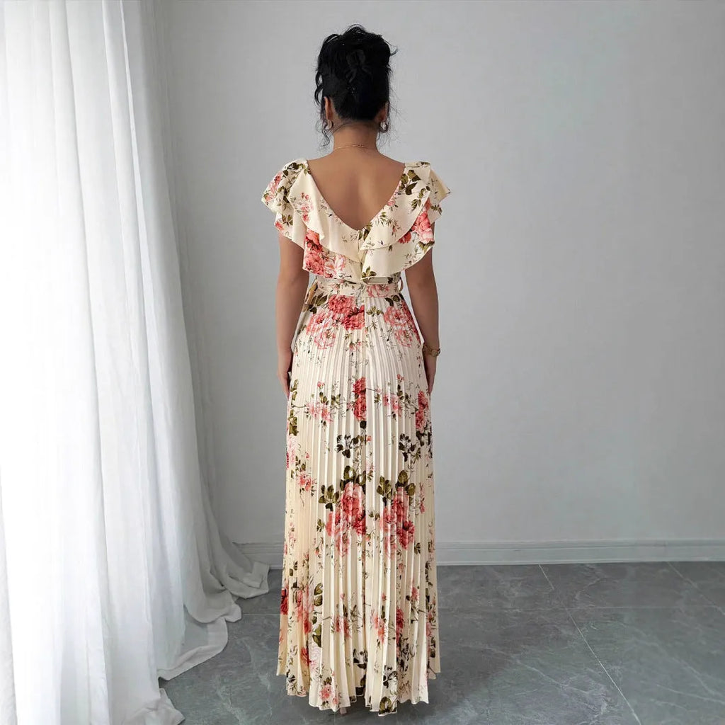 Apricot V-neck dress with digital floral print, ruffled short sleeves, and oversized pleated swing skirt.