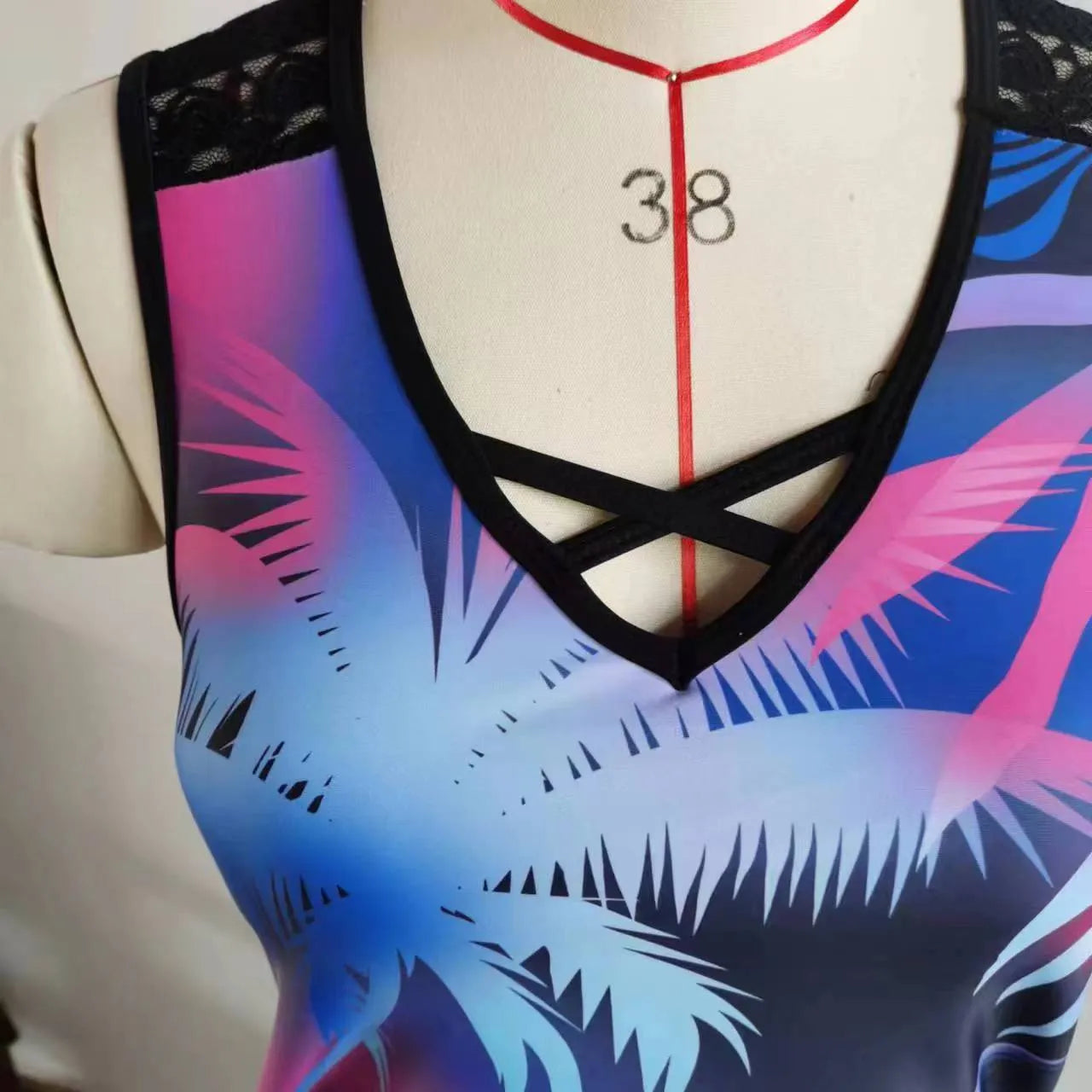 Women's blue printed lace two-piece swimsuit with a sleeveless top and brief shorts.