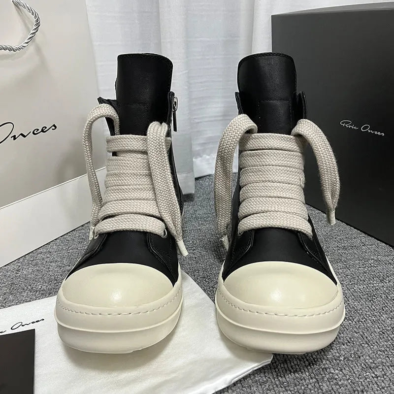 Black genuine leather high-top sneakers with side zip and stitching details on round toe design