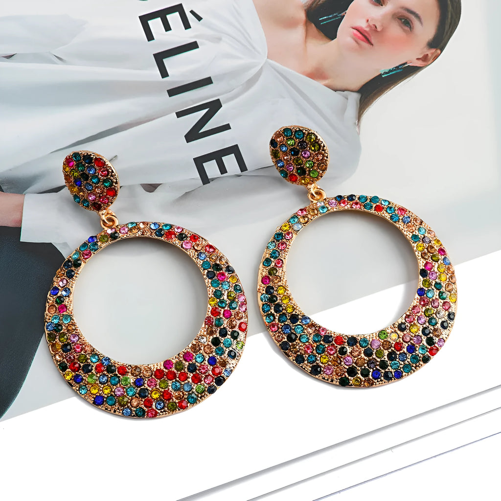 Colourful alloy metal earrings with large round diamond-look pendants in cartoon style