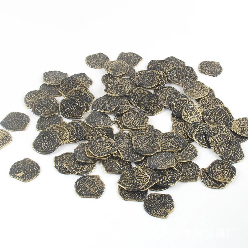 Close-up of gold, silver, and bronze plastic replica Roman pirate coins from a 100-piece set.