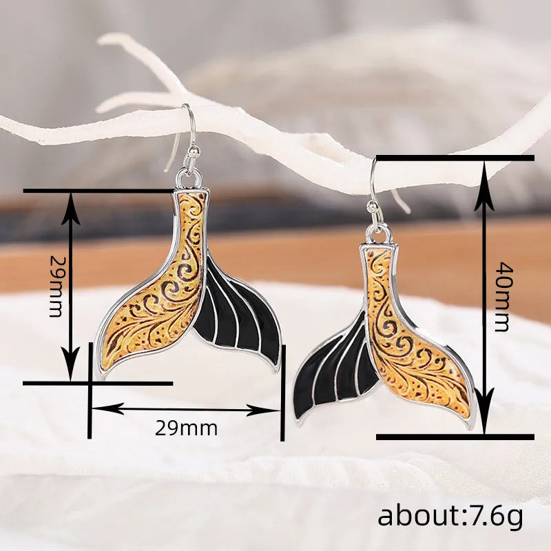 Women's white gold colour fishtail earrings with whale charm detail on alloy