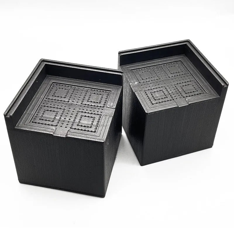 Black plastic bed and sofa foot risers four pack for furniture height adjustment