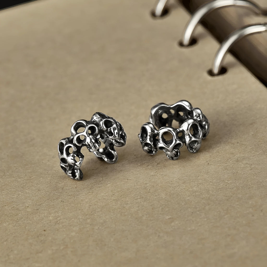 Stainless steel clip-on earrings with hollow geometric skull design in electroplated finish