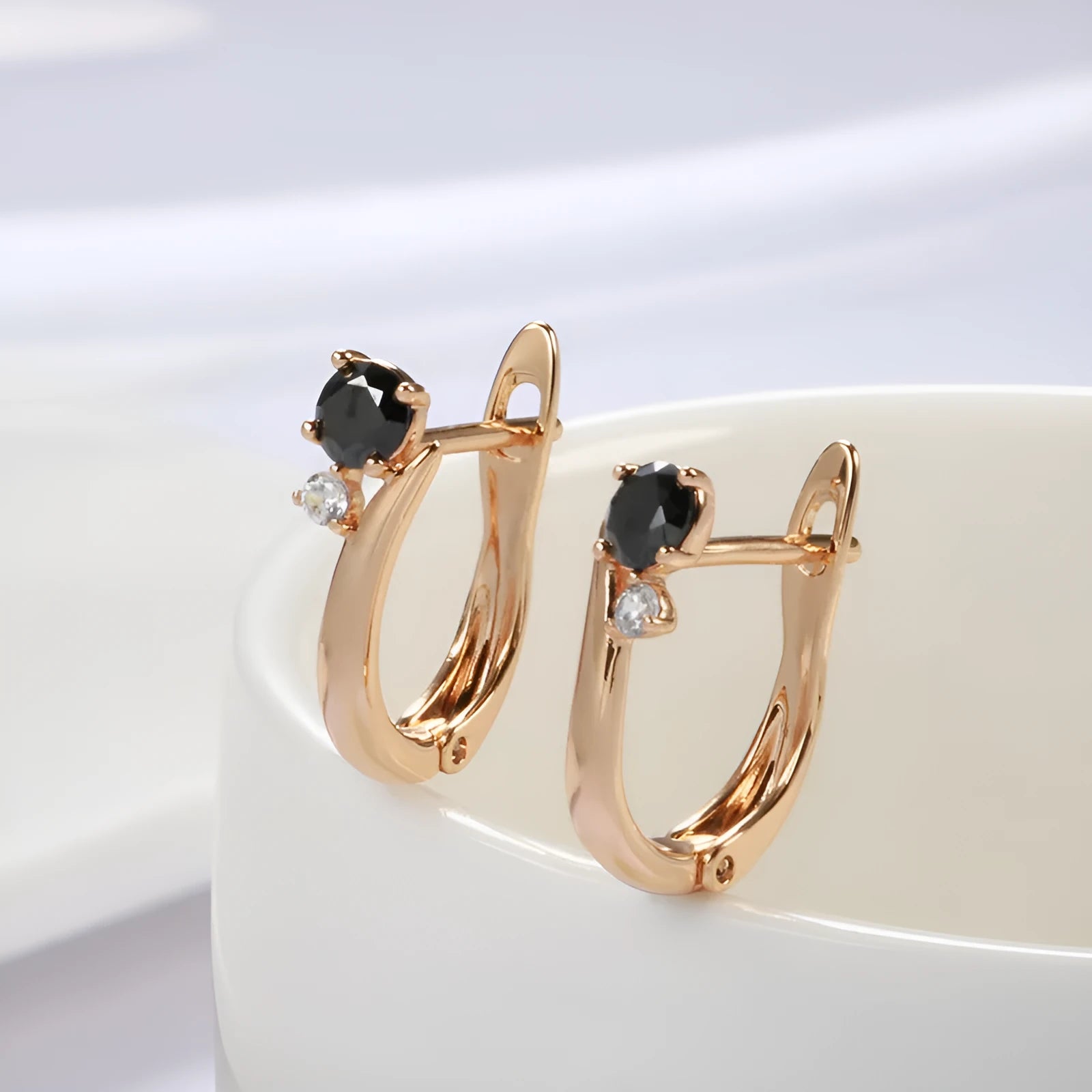 Gold geometric drop earrings with black agate stone styling