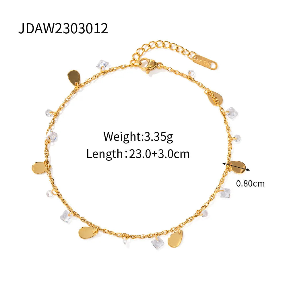 Close-up of a women's stainless steel anklet with a geometric water drop tassel charm on an adjustable chain.