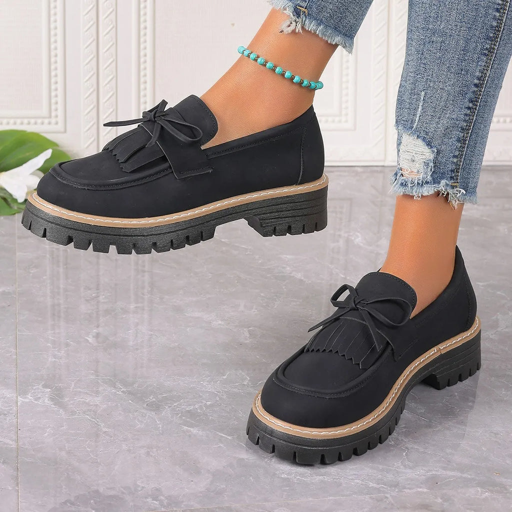 Brown plus size women's loafers with a tassel and bowknot detail on a chunky thick heel.