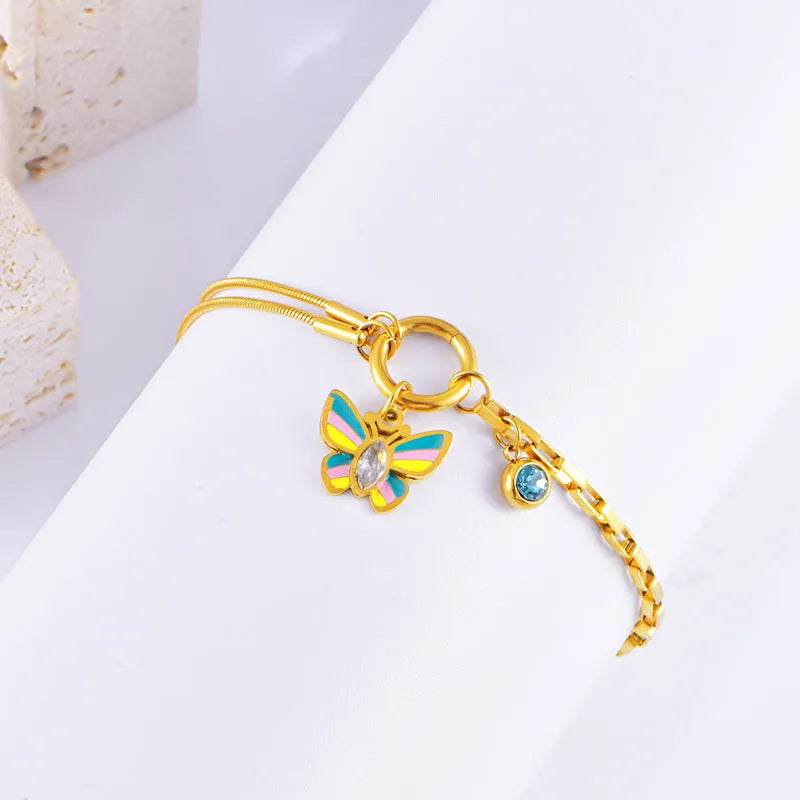 Gold titanium steel butterfly jewellery set with colourful epoxy pendant on snake bones chain