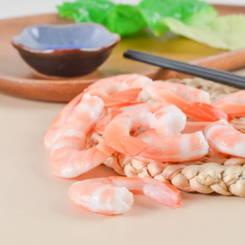 Realistic PVC shrimp-shaped keychain with door buckle attachment on white background.