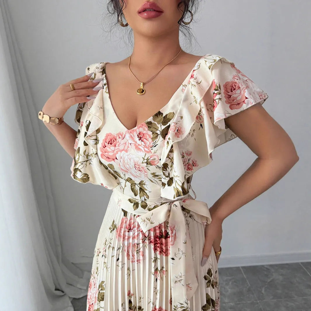 Apricot V-neck dress with digital floral print, ruffled short sleeves, and oversized pleated swing skirt.