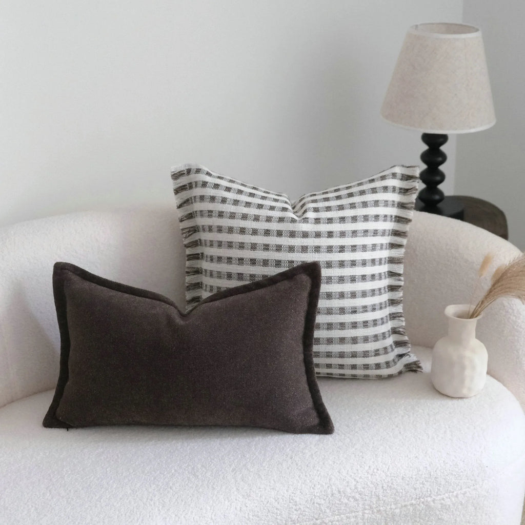Coffee brown striped Chinese classical style sofa cushion on a living room sofa.