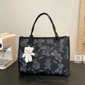 Women's black and white printed canvas tote bag with rhombus pattern showing large capacity and shoulder strap