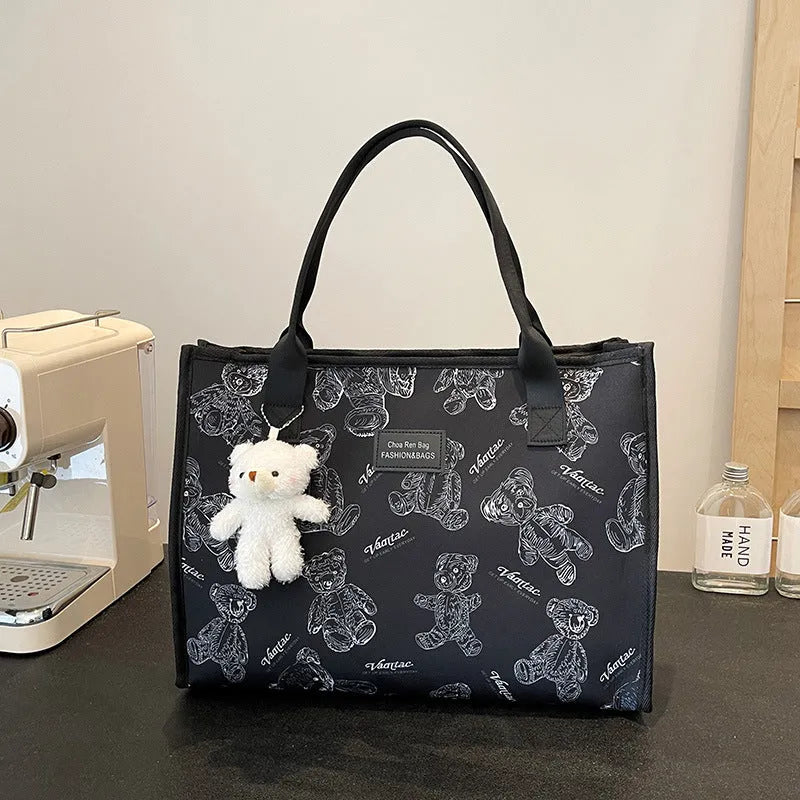 Women's black and white printed canvas tote bag with rhombus pattern showing large capacity and shoulder strap