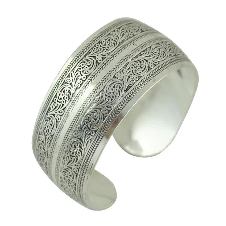Carved openwork Miao ethnic bracelet in alloy with diamond-cut treatment showing detailed patternwork