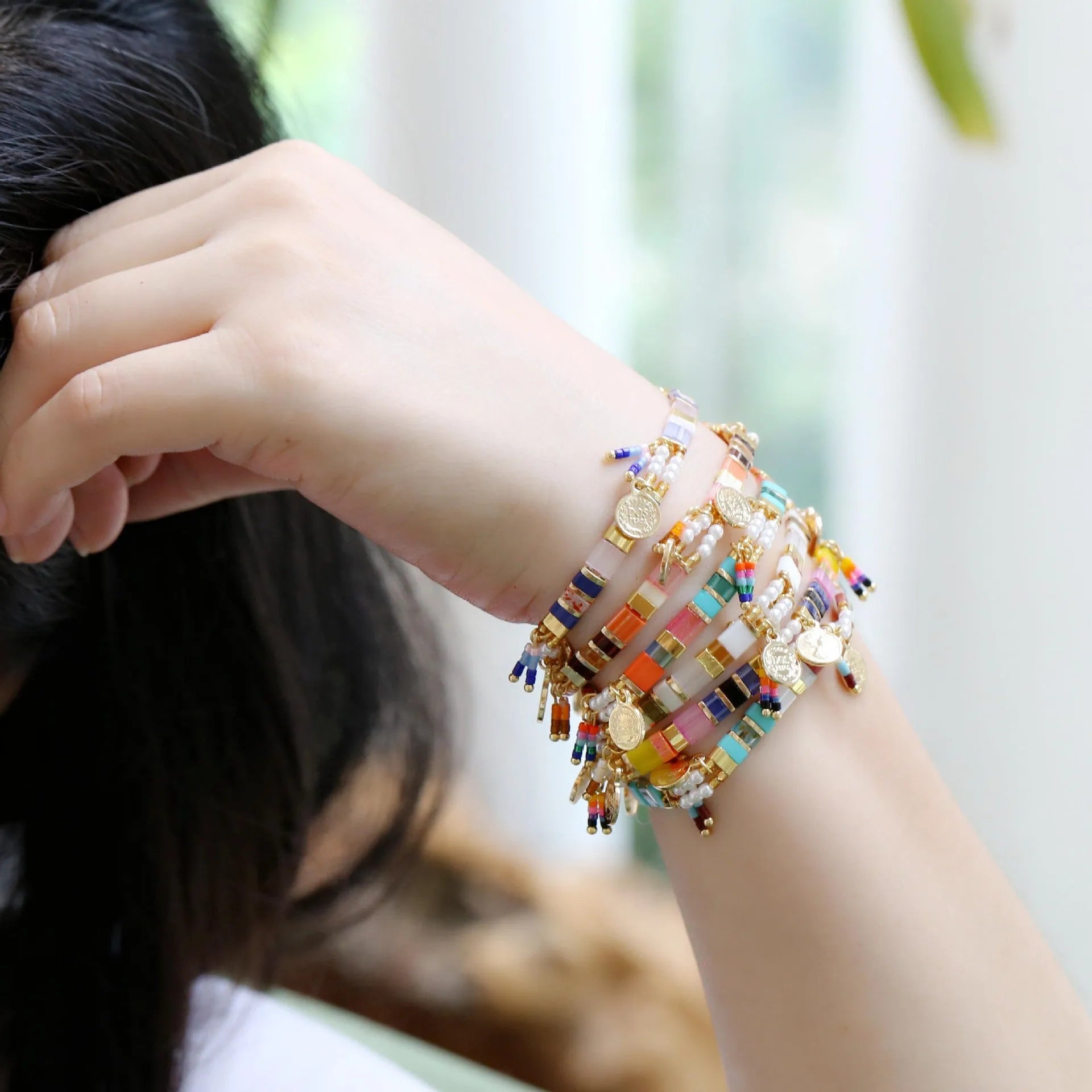 Women's imitation pearl beaded bracelet showing six pearl-lift colour variations with manual processing