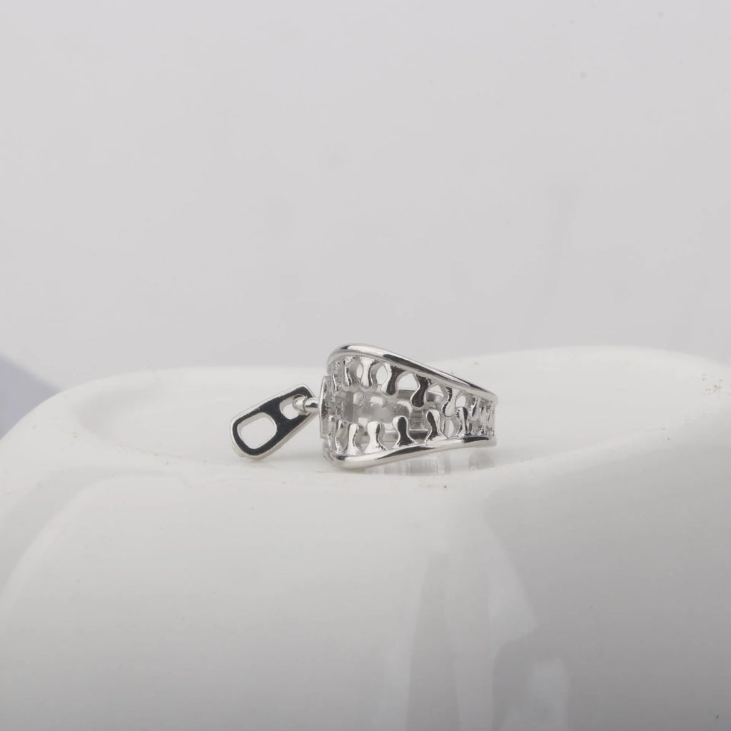 A pair of geometric copper clip-on earrings with a bone clip fastening and linear detail.