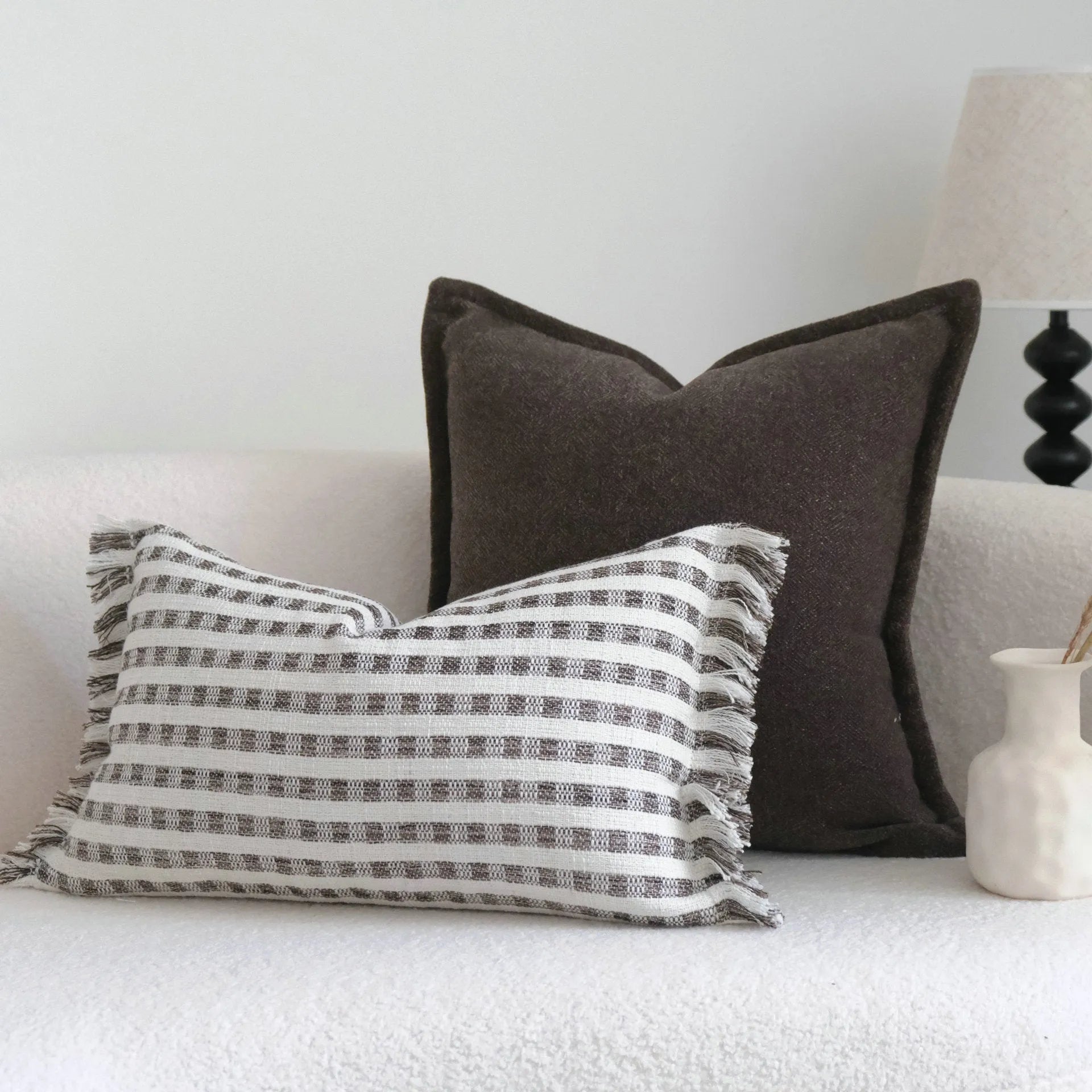 Coffee brown striped Chinese classical style sofa cushion on a living room sofa.