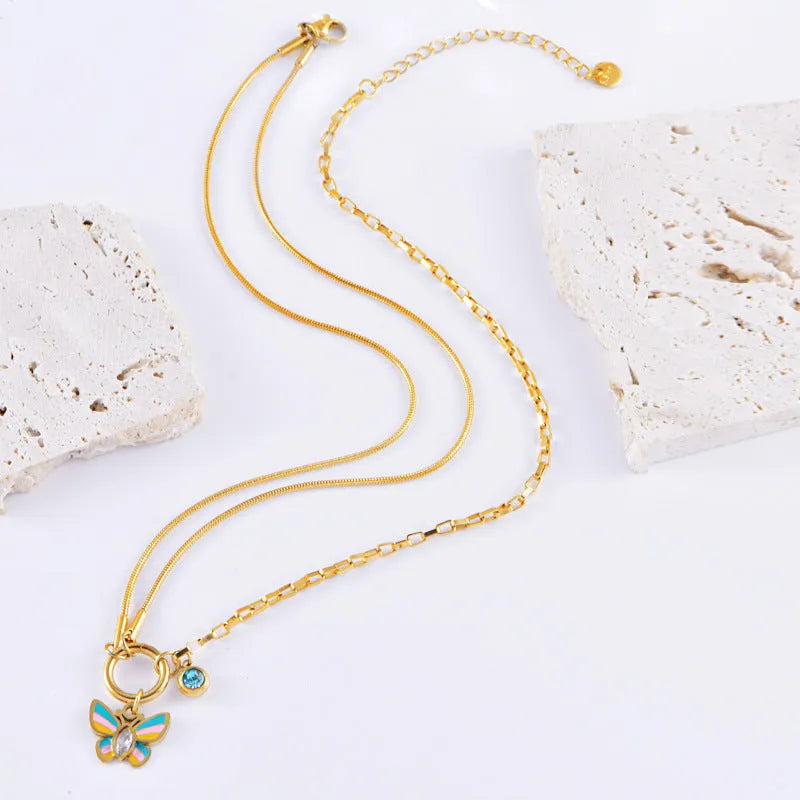 Gold titanium steel butterfly jewellery set with colourful epoxy pendant on snake bones chain