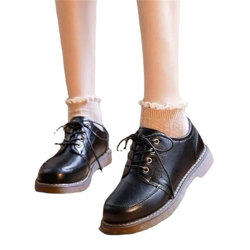 Women's black retro Mary Jane lace-up pumps with round toe and low square heel on a white background.