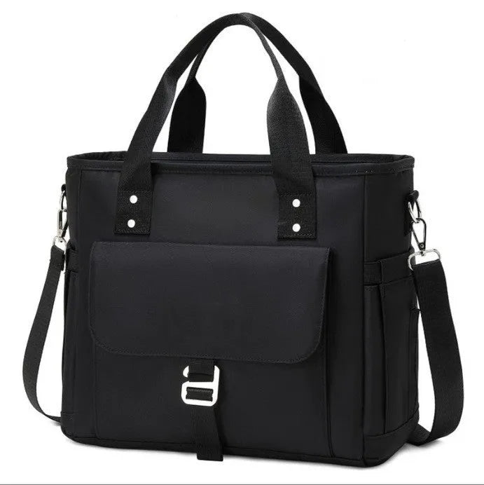 A portable cube-shaped picnic bag with a removable shoulder strap and a side pocket, shown in pink colour.
