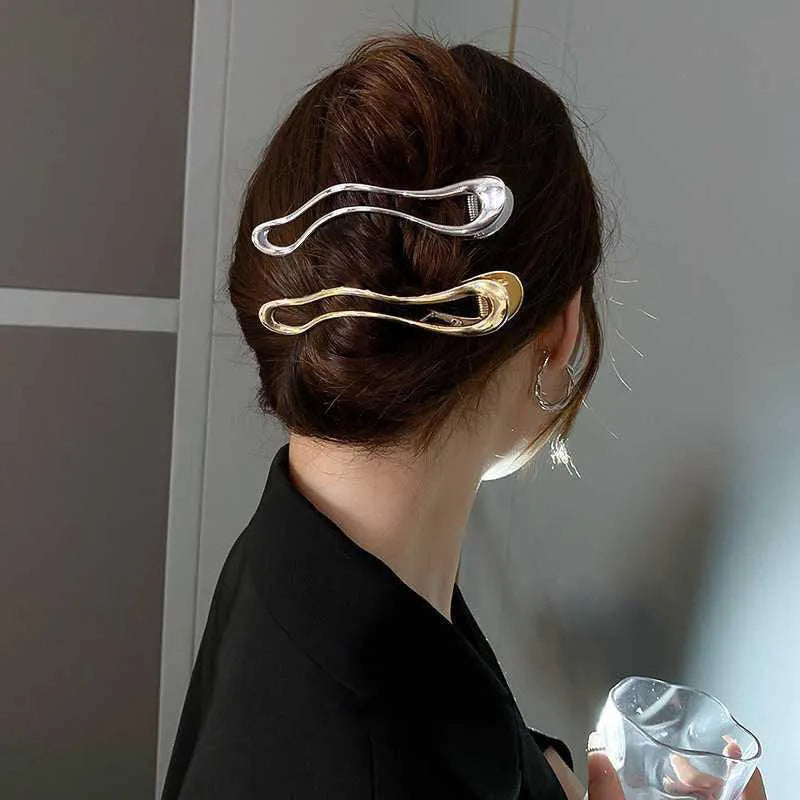Gold and silver geometric zinc alloy hair clips showing arc, square, and triangle shapes