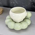 Ceramic coffee cup and saucer set in a choice of five colours, including coffee brown and bean green.
