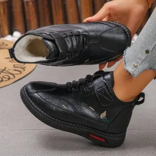 Black and red women's velvet indoor shoes with rubber soles and low tube socks design.