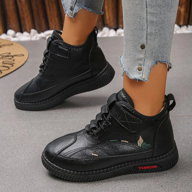 Black and red women's velvet indoor shoes with rubber soles and low tube socks design.