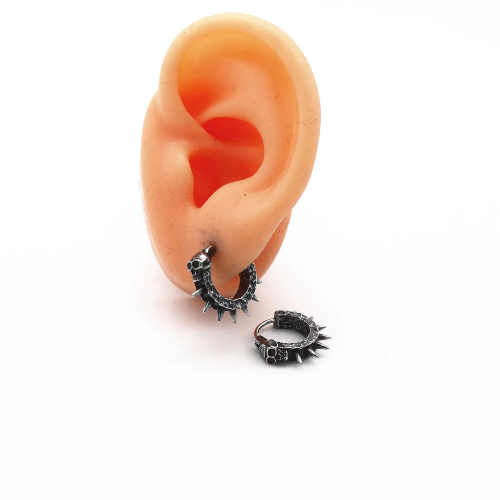 A pair of retro black alloy earrings with a geometry shape, designed with a punk motorcycle aesthetic.