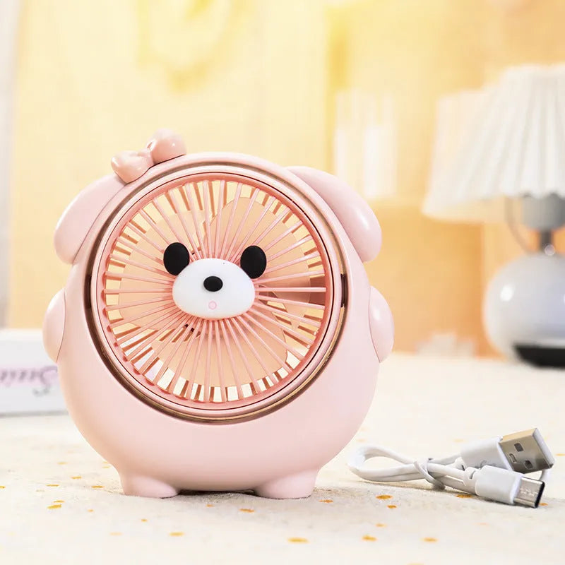 Cute dog-themed USB desktop electric fan in one of six colour options on a desk.