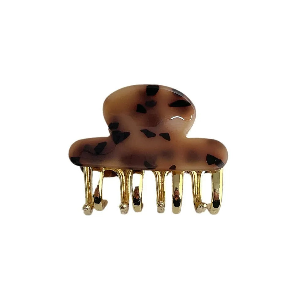Retro acetate hair grip with metal clamp in medium size, showing irregular pattern on surface