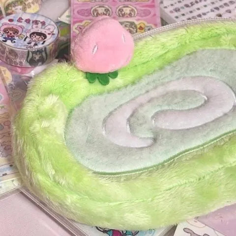 Velvet pencil case with a Swiss roll cake design, shown in a rolled-up position.