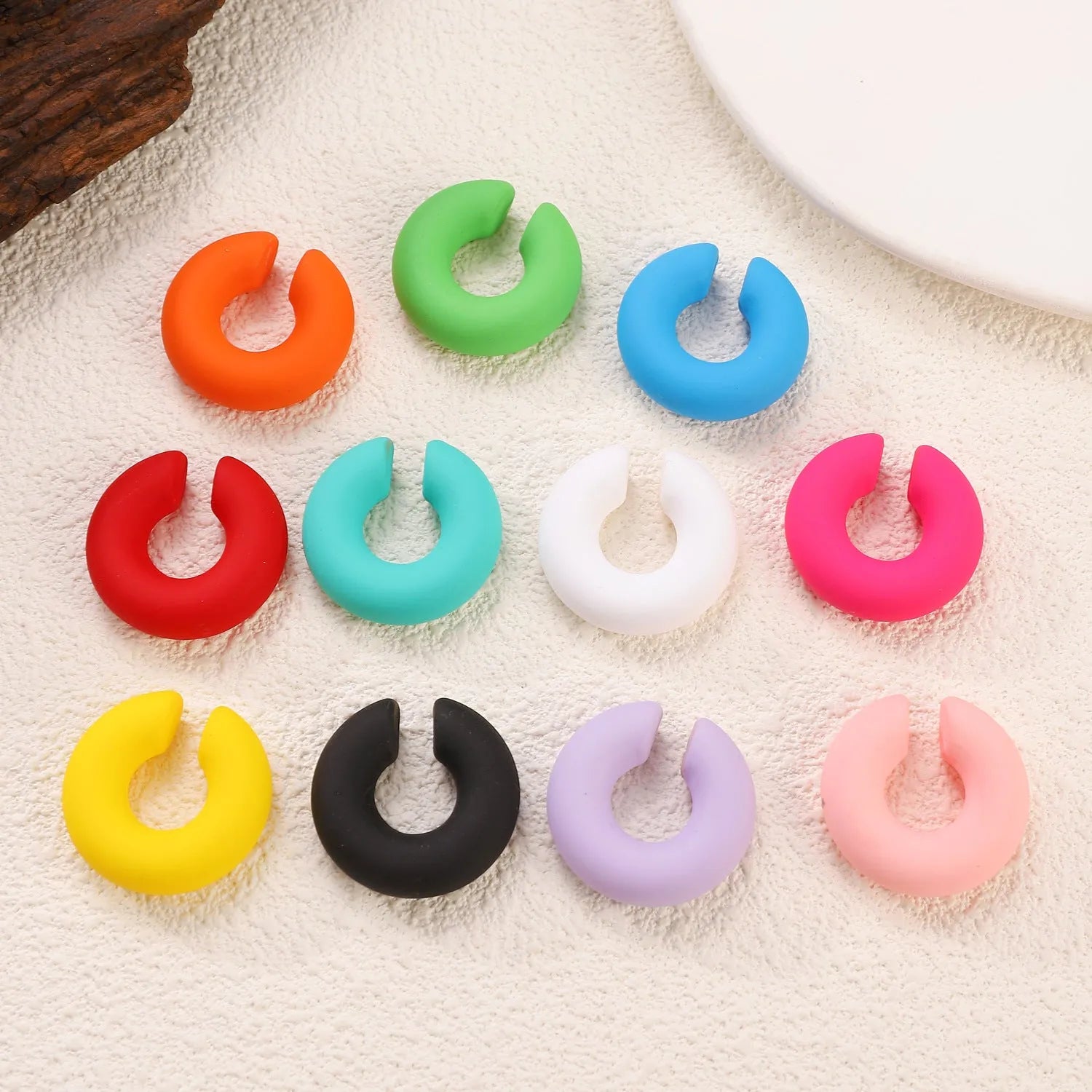 Matte finish C-shaped geometric clip-on earrings in assorted candy colours
