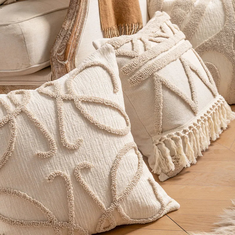 Knitted decorative pillow cover with tassels in a striped print design.