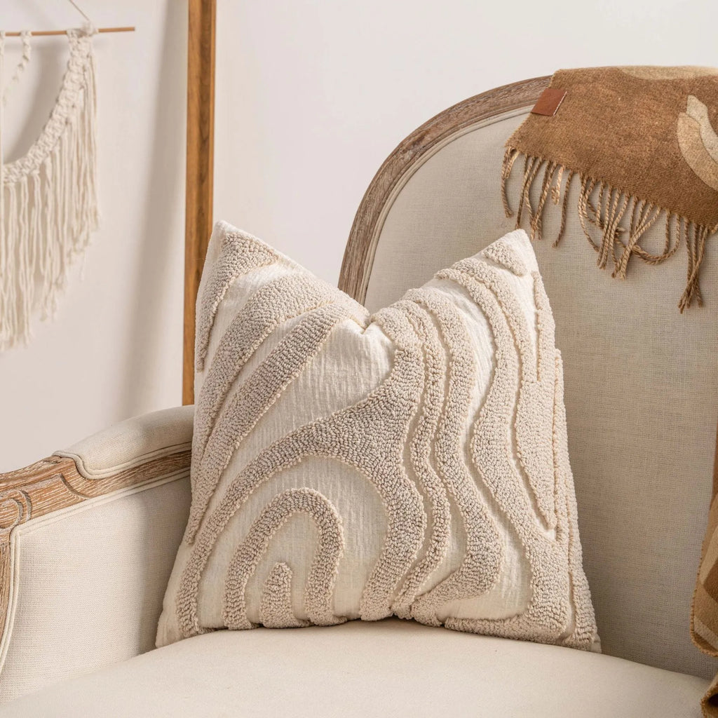 Knitted decorative pillow cover with tassels in a striped print design.