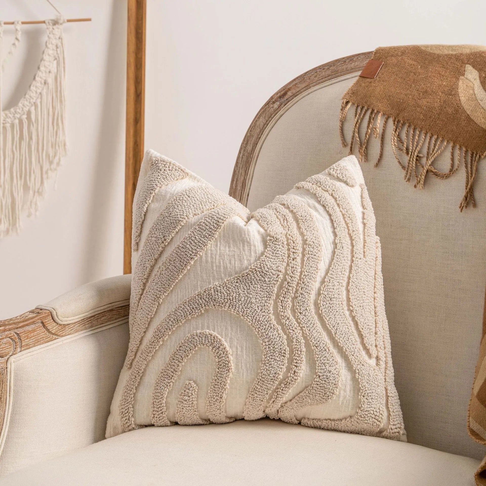Knitted decorative pillow cover with tassels in a striped print design.