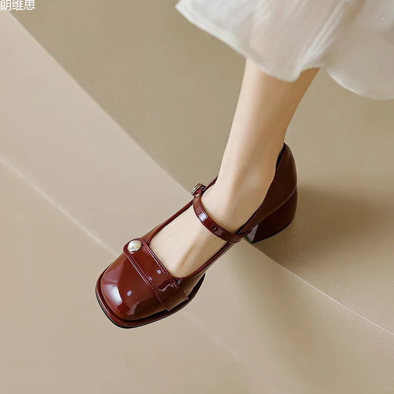 French-style women's chunky heel pumps with patent leather upper and buckle fastening