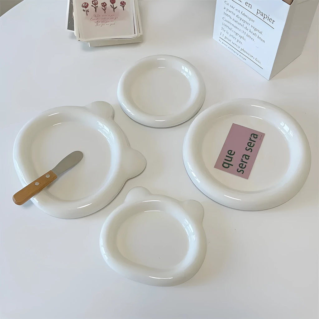 White ceramic ins-style plate with doodle design, shown in bear and round patterns in two sizes.