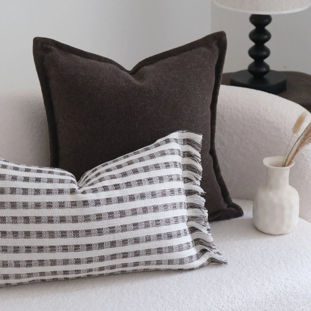 Coffee brown striped Chinese classical style sofa cushion on a living room sofa.